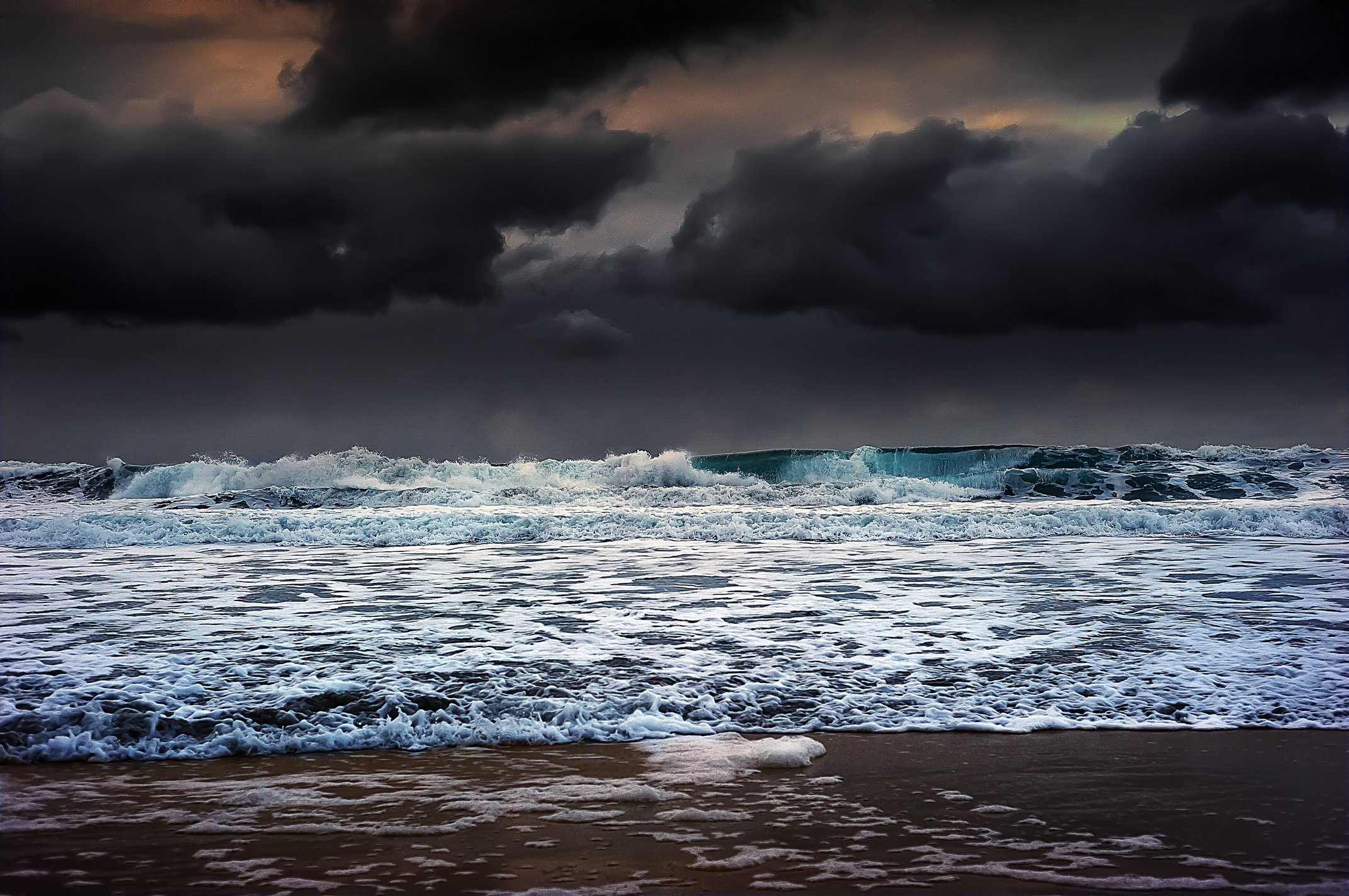 Crashing Waves Under Dark Rainy Sky